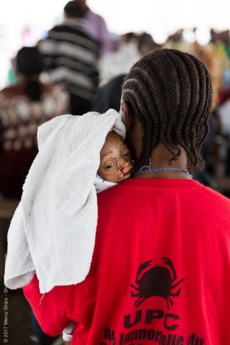 Baby Paul, cleft lip and palate patient, waiting with his mother during screening.