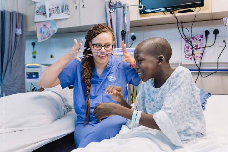 Hannah Thyberg, Pediatric Ward Nurse, playing cat's whiskers with one of her patients.